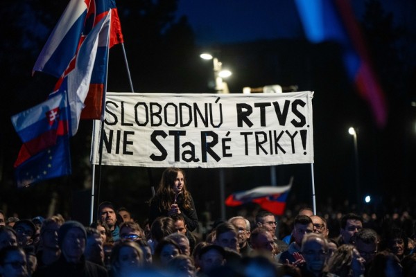 A protester with a placard 'Freedom for Radio and Television of Slovakia (RTVS) not the old tricks' takes part in a demonstration against the government's plan of reorganization of RTVS public broadcaster, in Bratislava, Slovakia, 15 March 2024. - EPA-EFE/JAKUB GAVLAK