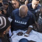 Relatives of Palestinian journalist Samer Abu Daqqa, cameraman for Al Jazeera, who was killed during Israeli air strikes in the southern Gaza Strip, with press crews next to his wrapped body, outside Nasser Hospital in Khan Yunis, southern Gaza Strip, 16 December 2023. EPA-EFE/HAITHAM IMAD