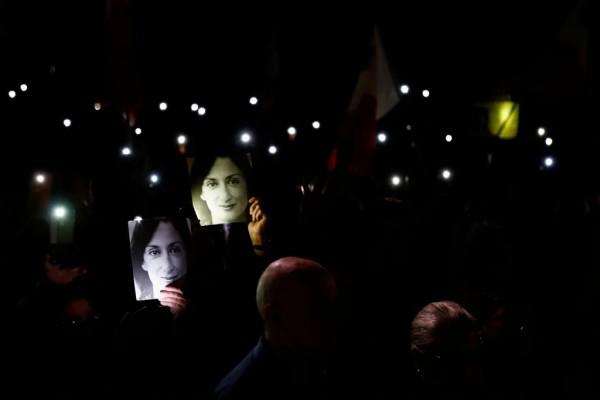 People hold up their phones after a protest march on the fifth anniversary of the assassination of journalist Daphne Caruana Galizia in Valletta, Malta, on October 16, 2022. Press freedom groups are calling for reforms to improve media safety in Malta. Credits: Reuters/Darrin Zammit Lupi