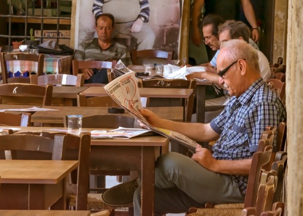 Men reading newspapers in a cafe in Nicosia, Cyprus. Credits: Shutterstock / Tanya Kalian